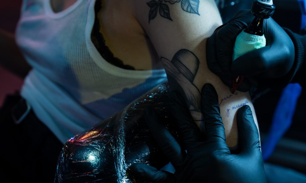 Close Up Of Needle And Ink For Tattoo On Skin